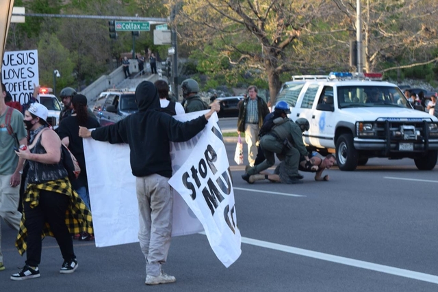 Photo of the arrest. He had already thrown his backpack to safety at this point.